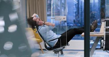 businessman sitting with legs on desk photo