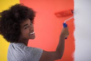 black woman painting wall photo