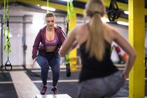 athletes working out  jumping on fit box photo