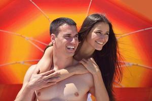 happy couple have fun on the beach photo