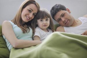 happy family relaxing in bed photo