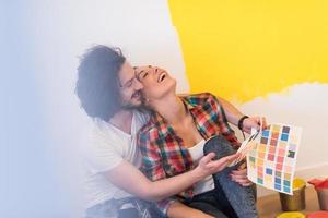 Happy young couple relaxing after painting photo