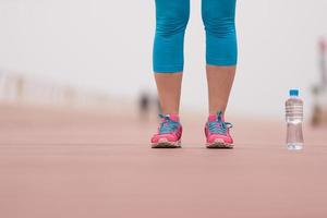 close up on running shoes and bottle of water photo