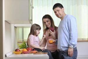 happy young family in kitchen photo