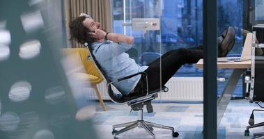 businessman sitting with legs on desk photo