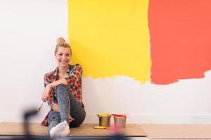 young female painter sitting on floor photo