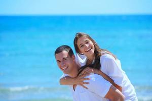 happy couple have fun on the beach photo