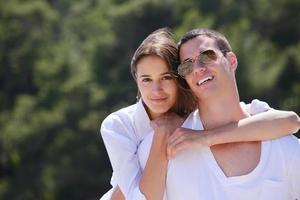 happy couple have fun on the beach photo