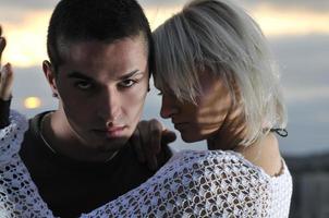 romantic urban couple dancing on top of the bulding photo