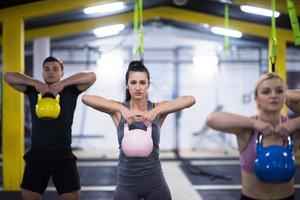 athletes doing exercises with kettlebells photo