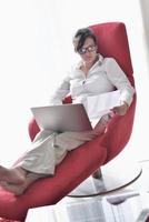 woman using a laptop computer at home photo