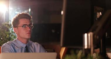 man working on computer in dark office photo