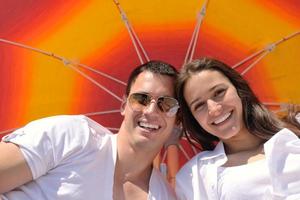 happy young couple have fun on beach photo