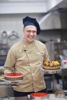 chef preparing desert cake in the kitchen photo