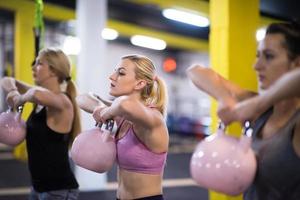 athletes doing exercises with kettlebells photo