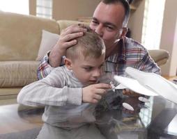 father and son assembling airplane toy photo