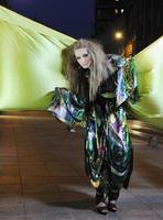 elegant woman on city street at night photo