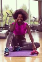 mujer afroamericana ejercicio yoga en el gimnasio foto