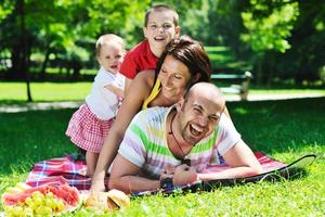 happy young couple with their children have fun at park photo