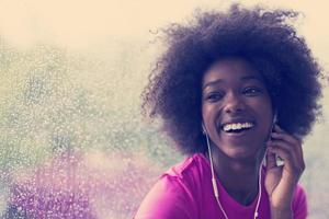 portrait of young afro american woman in gym while listening music photo