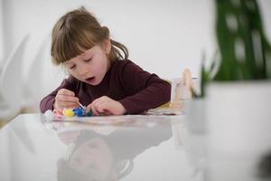 little girl painting on canvas photo