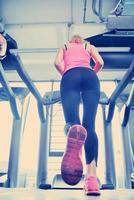 woman exercising on treadmill in gym photo