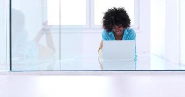 black women using laptop computer on the floor photo