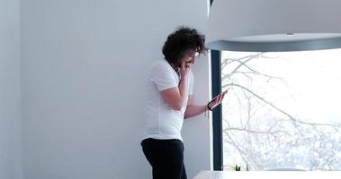 young man using a tablet at home photo