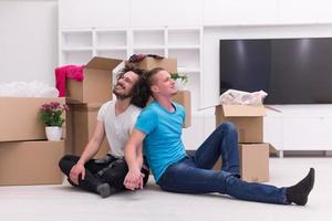 young  gay couple moving  in new house photo