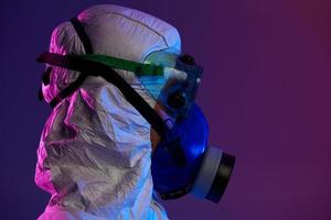 Doctor wearing protective biological suit and mask due to coronavirus photo