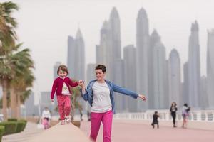 mother and cute little girl on the promenade photo