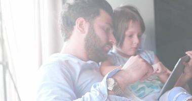 Father Daughter using Tablet in modern apartment photo