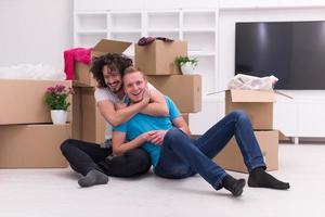 young  gay couple moving  in new house photo
