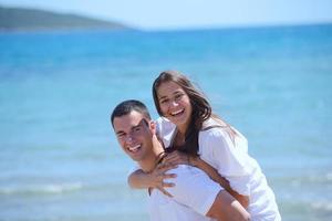 happy young couple have fun on beach photo