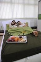 happy young family eat breakfast in bed photo