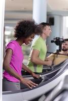 people exercisinng a cardio on treadmill in gym photo