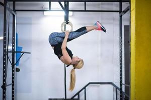 mujer trabajando en anillos de gimnasia foto