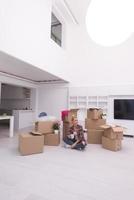 woman with many cardboard boxes sitting on floor photo