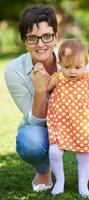 mother and baby in park making first steps photo