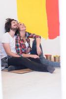 Happy young couple relaxing after painting photo