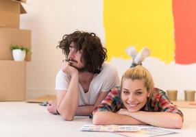 Happy young couple relaxing after painting photo