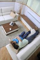 couple relax at home on sofa in living room photo