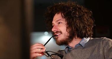 man working on computer in dark office photo