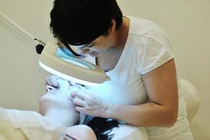 woman with facial mask in cosmetic studio photo