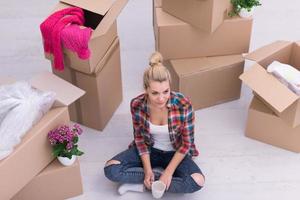 woman with many cardboard boxes sitting on floor photo