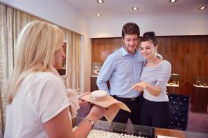 happy young couple in jewelry store photo