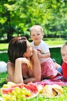 woman and baby playing at park photo