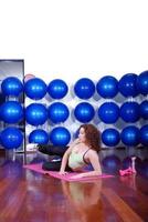 young pretty woman exercising in a fitness center photo