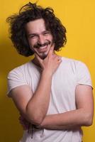 young man with funny hair over color background photo