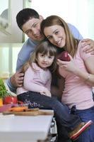 happy young family in kitchen photo